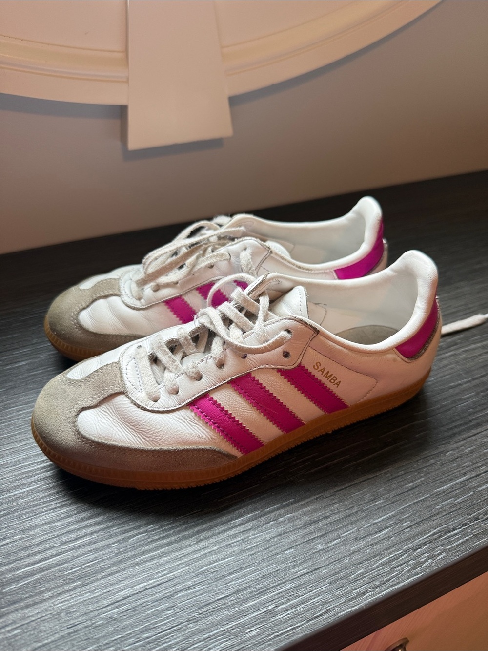 Adidas Samba sneakers in white with bright pink stripes and classic gum sole.